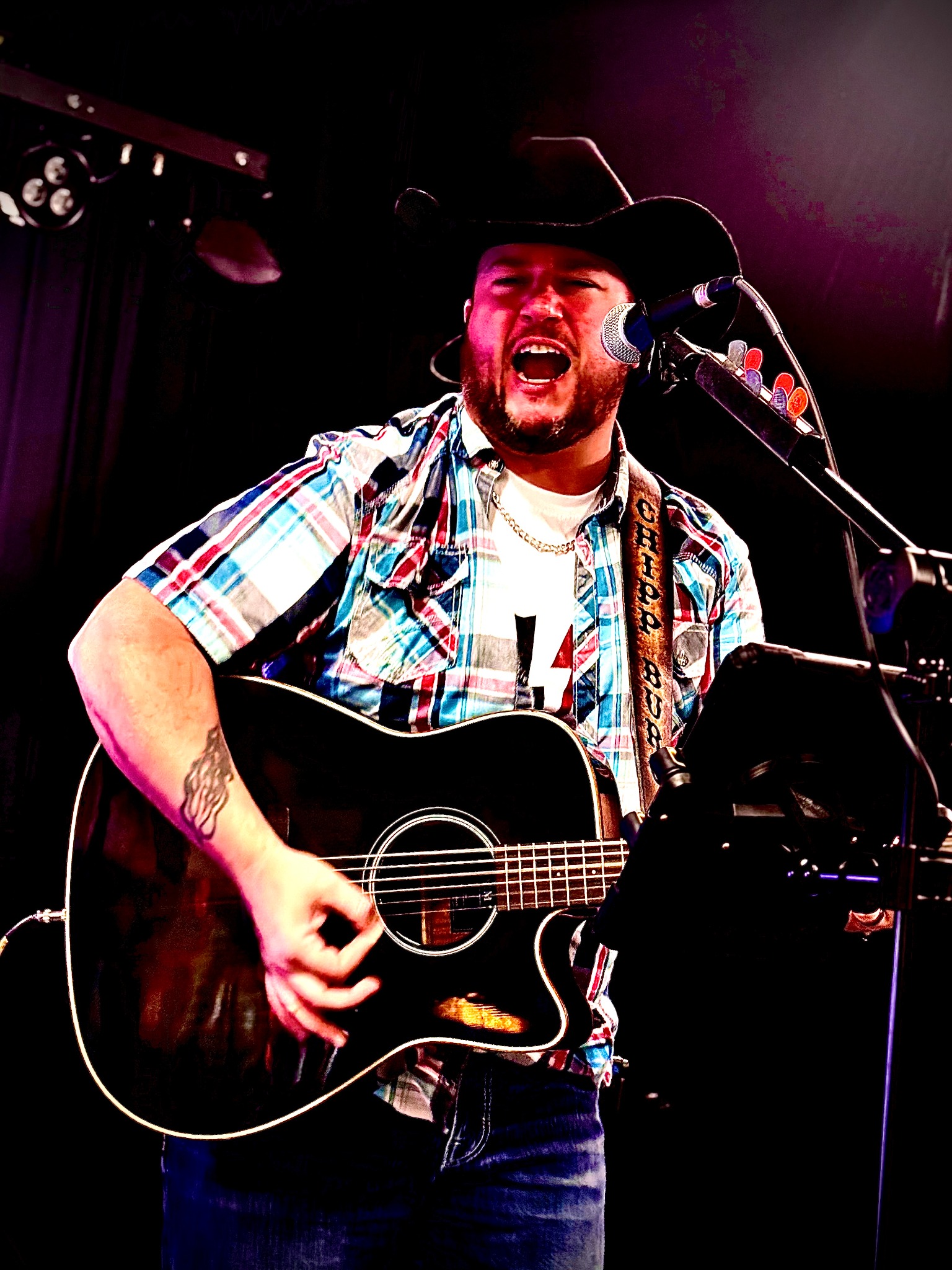 Chipp Burg performing live with his acoustic guitar